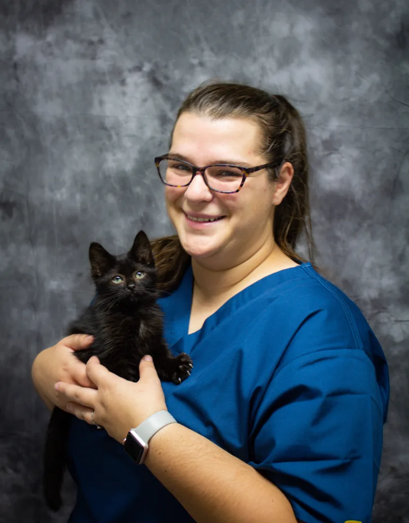 Hallie holding a little black kitten